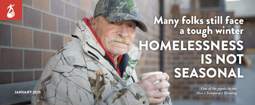 Homeless man with a cup of coffee, sitting outside in the cold.